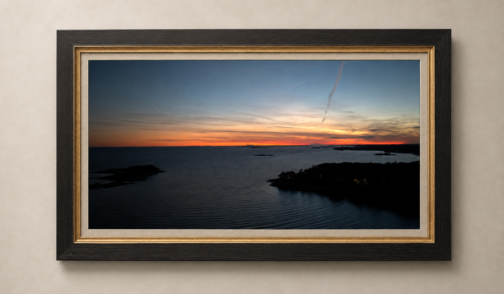 Passage at Dusk, an aerial view across Atlantic water and islands beneath a red-orange dusk horizon, presented in the bespoke Atlantic Cove frame